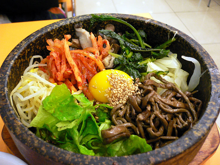 Bibimbap is a delightful Korean Dish - mixed rice served in a stone bowl. See the delightful recipes here to learn how to cook Bibimbap at home 