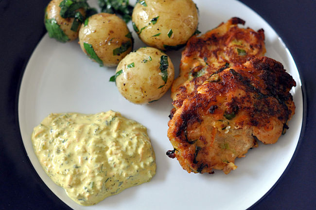 Fish cakes served with potatoes and a salad side serve 