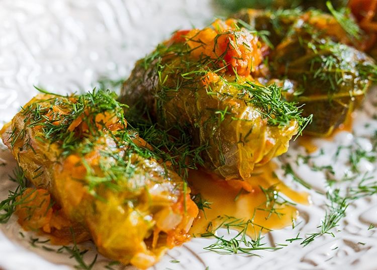 A spicy sauce and a sprinkling of herbs add to the interest and intrigue of stuffed cabbage rolls.