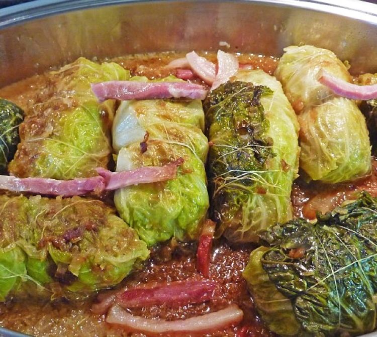 The bound cabbage rolls can be simmered gently in a tasty sauce to cook the fillings and blend the ingredients