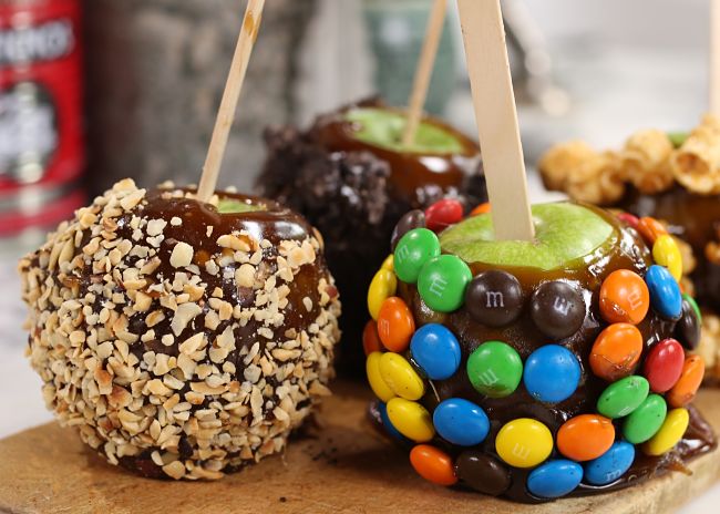 Dipping toffee apples into crushed nuts, sprinkles and other options is easy to do and creates delightful variations