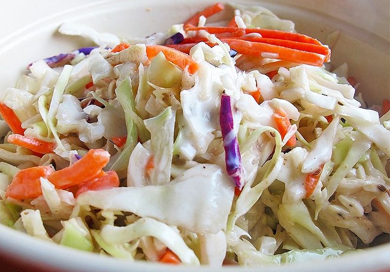 Carrots, onions, peppers and a range of herbs can be added to coleslaw to boose the flavor and appeal.