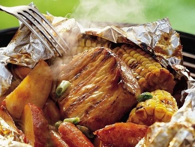Using an oven bag wrapped in foil provides the best of both worlds. The bag retains moisture and the foil protects the bag from the flames and grill. 