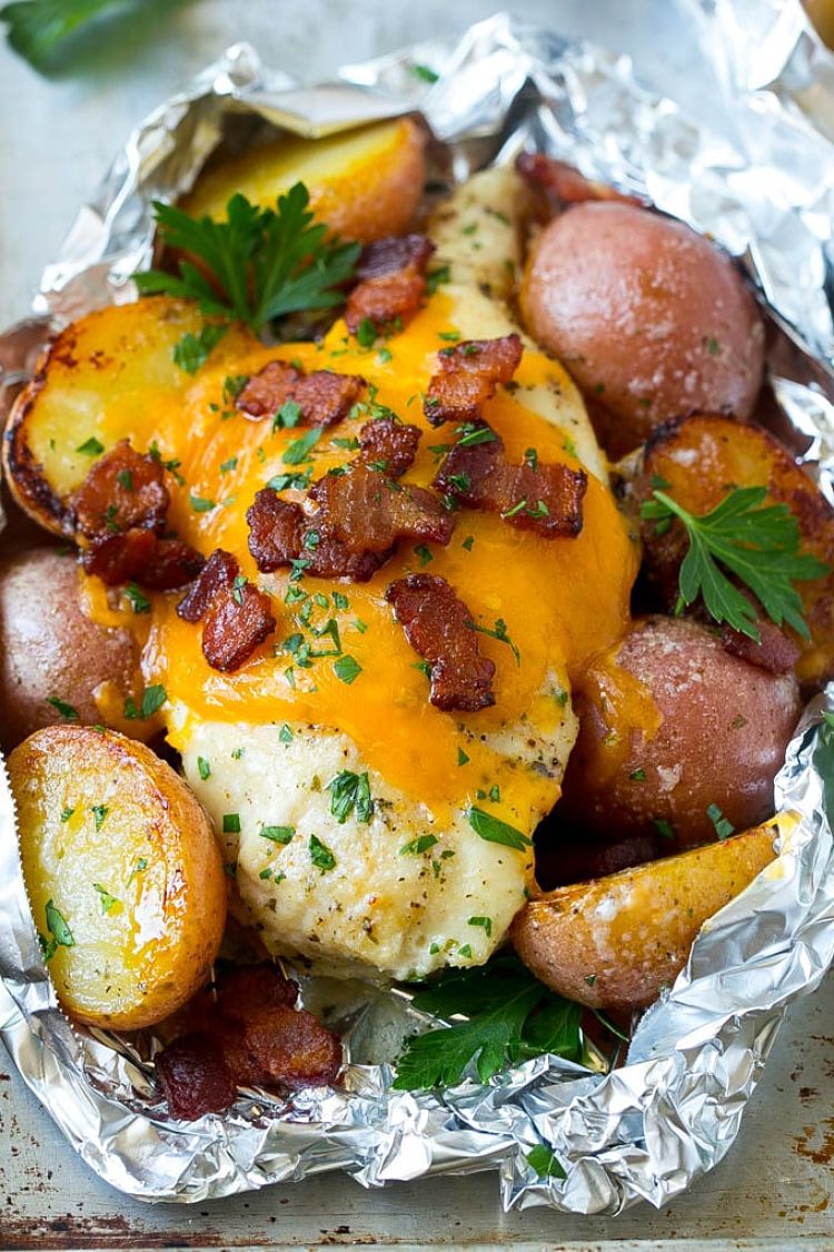 Fish potatoes and herbs cooked in a foil packet