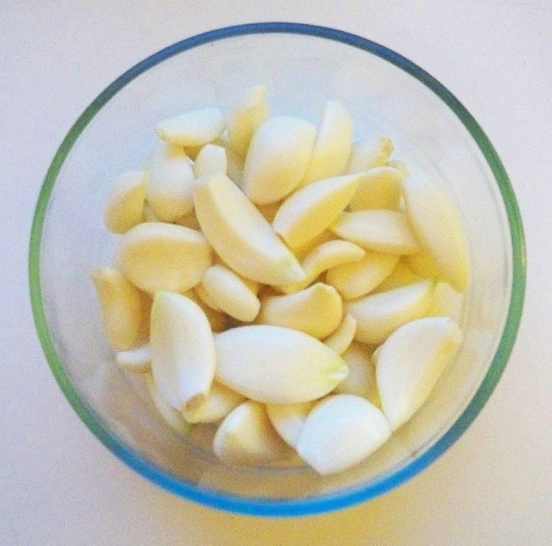 Before freezing garlic, peel the cloves, then blanch, chop or mince.
