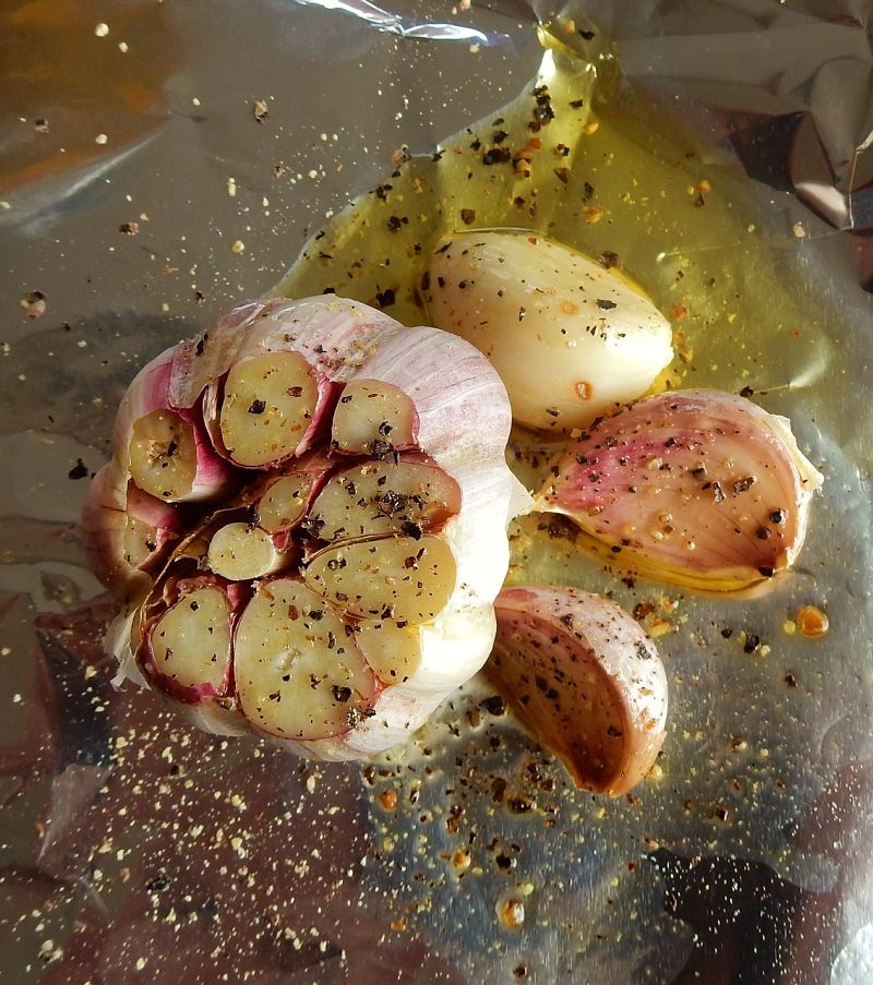 Garlic coated in olive oil can be frozen. The bulbs can be baked straight from the freezer pack