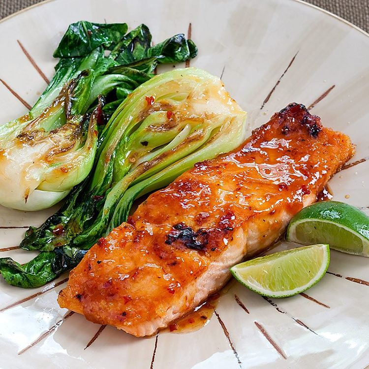 Grilled salmon with greens all covered with a spicy clear honey sauce