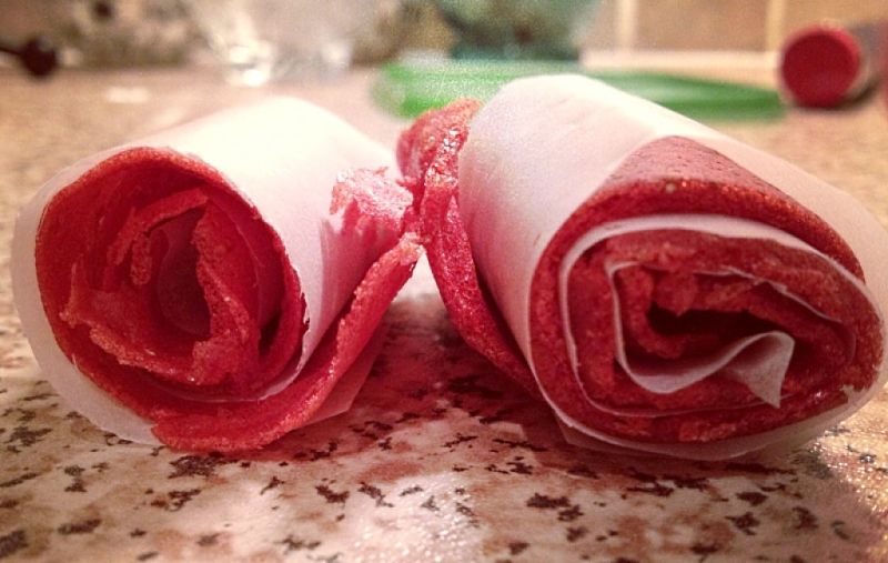 Rolled strips of fruit, lined with paper are a great snack for children's lunches