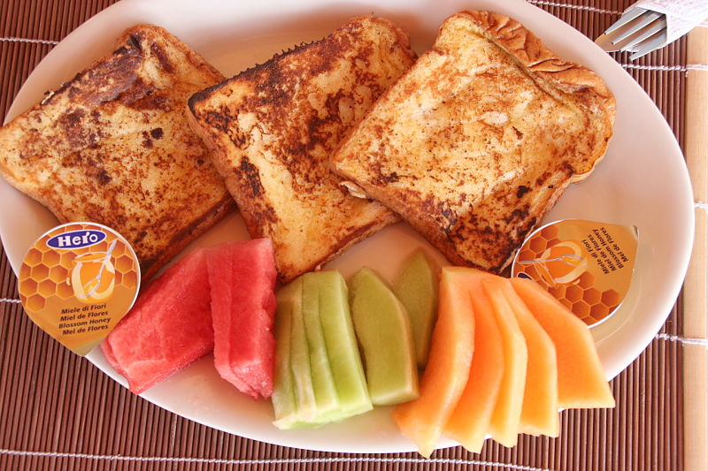Simple French Toast ready to eat and enjoy. Serve with honey and a variety of fresh fruit