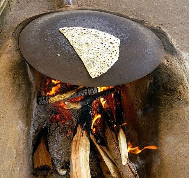 Traditional method of cooking Gozleme on a metal plate over and open fire which adds to the taste 