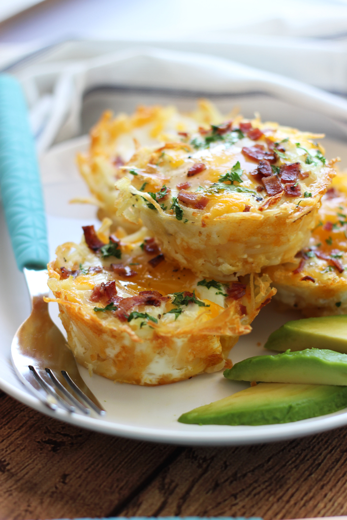 Shredded hash browns and cheese nests baked until crispy topped with a baked eggs, crumbled