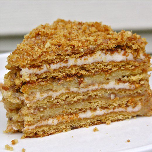 Layered honey cake with cream cheese filling, topped with almonds is a special treat