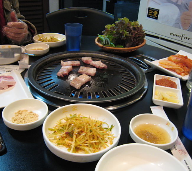 Gas burner style Korean barbecue cooker. You can do this at home with 'Baby' barbecues or camping units. See how in this article