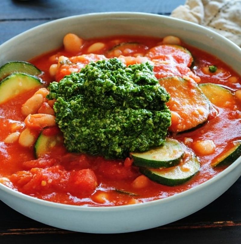 This version is rich in tomato and is topped with pesto