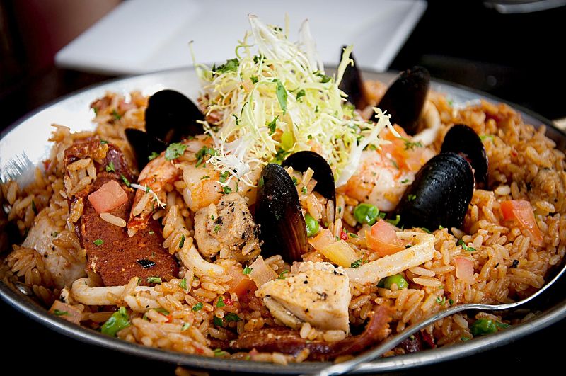 You can add chicken to a traditional seafood paella to add variety to the taste 