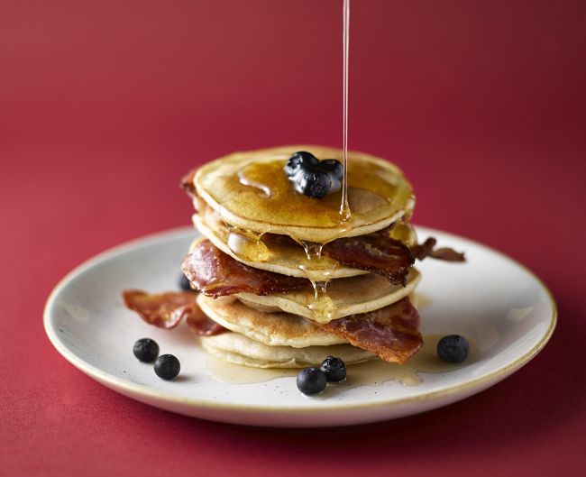 Breakfast pancakes with crispy bacon slices