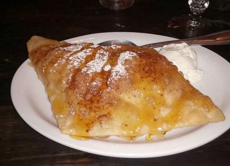 Lovely dessert sopapilla served with icing sugar and honey