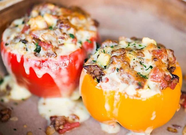Cheese as a topping for small stuffed peppers made for a snack, a light lunch, or a party