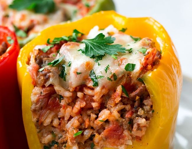 Pork Stuffed Peppers with rice, topped with melted cheese