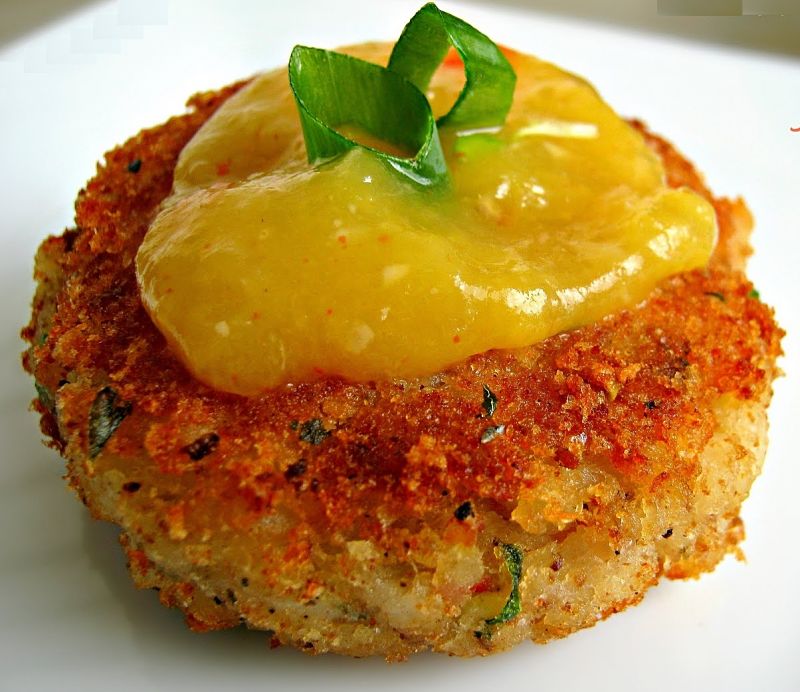 Spicy fish cakes with a mango sour sauce and fresh herbs