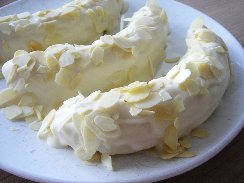 Banana covered with while chocolate and almond slices