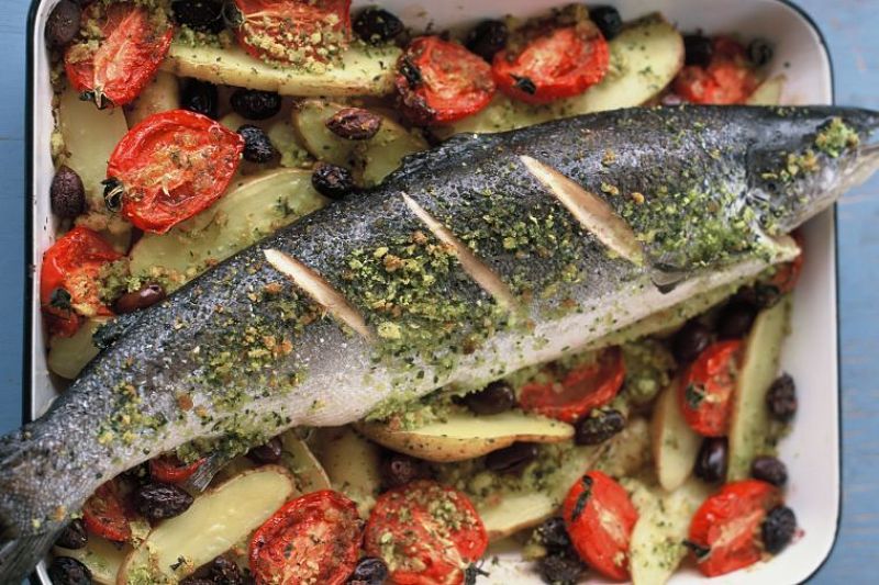 Beautiful grilled fish and various vegetables cooked on a barbecue