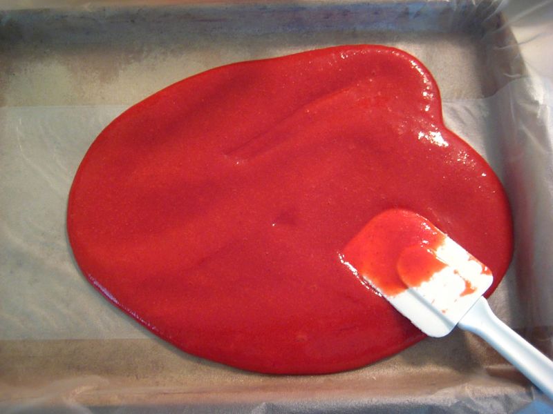 The blended fruit is poured into flat trays lined with baking paper ready for the oven