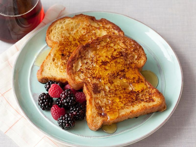 French toast with fresh fruit and drizzled with honey.