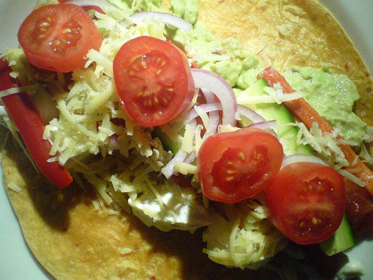 Lovely homemade tortilla with meat, lettuce, tomato and a delicious homemade sauce or salsa 