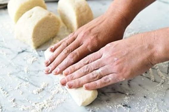 Rolling out the dough prior to slicing into the gnocchi shapes