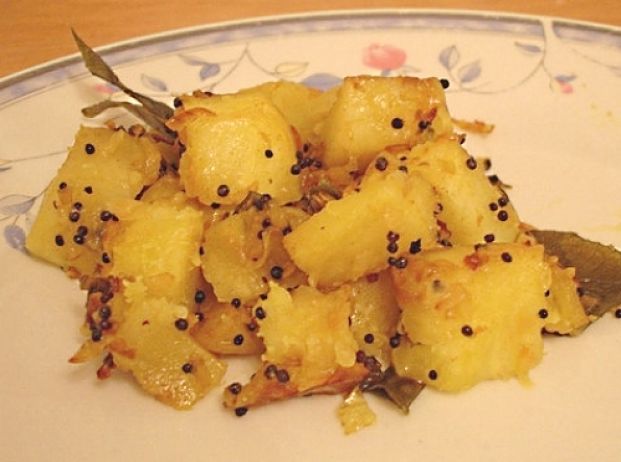 Boiled and Pan Fried Potatoes are delicious - soft on the inside and crisp on the outside. Follow the recipe for this delightful side-dish with whole garlic cloves, Rosemary springs and cheese chunks