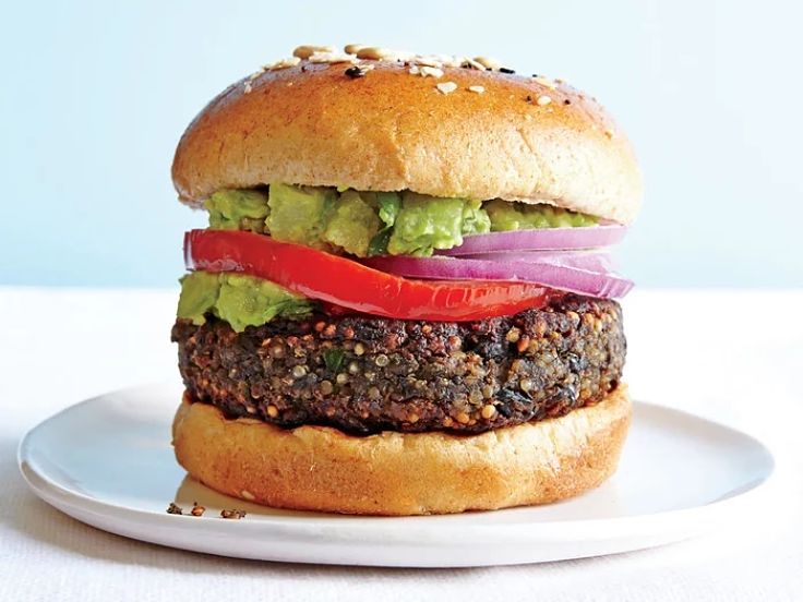 Very neat veggie burger with fresh tomato and salad